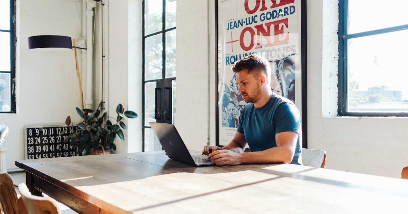 Founder working at a laptop managing startup runway and burn rate