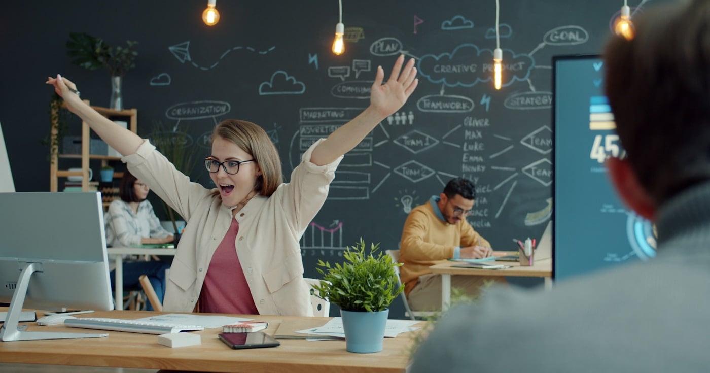 Startup team celebrating success in a modern office