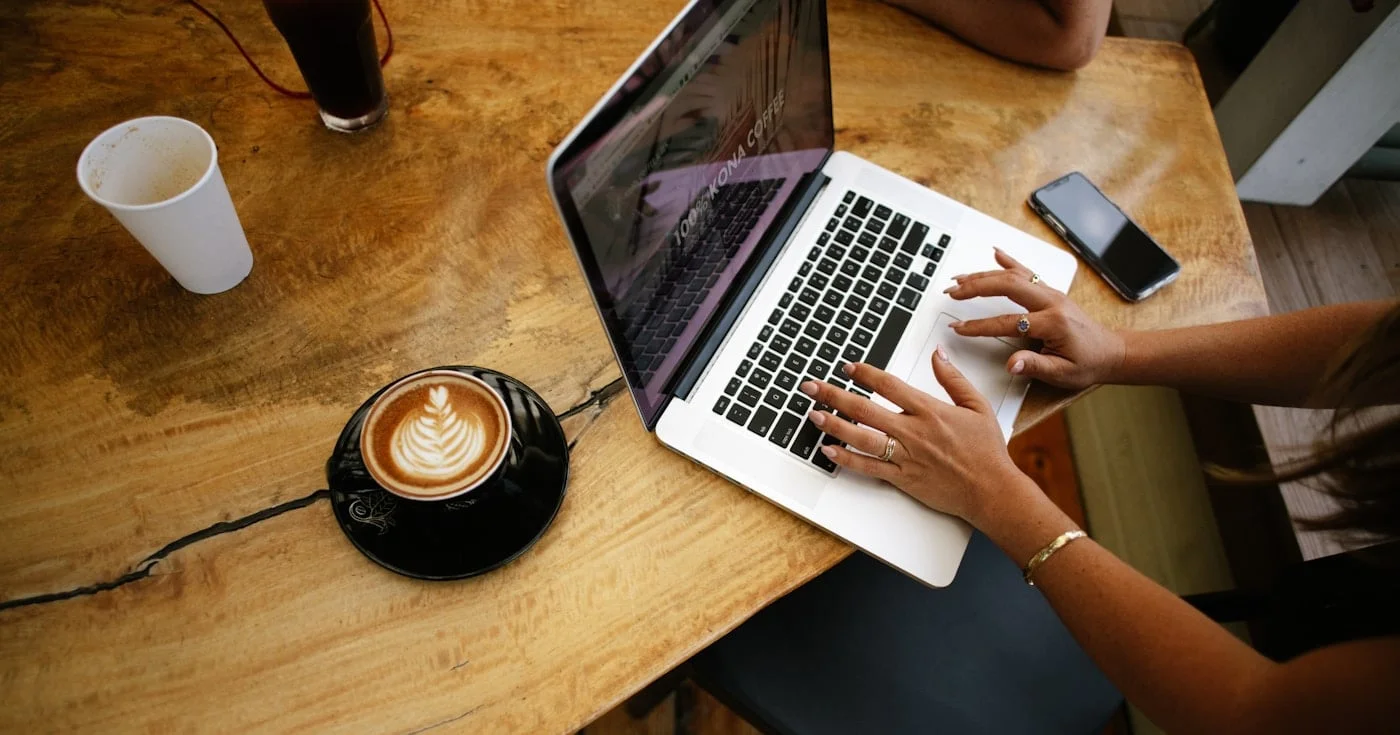Founder working on a laptop at a café table