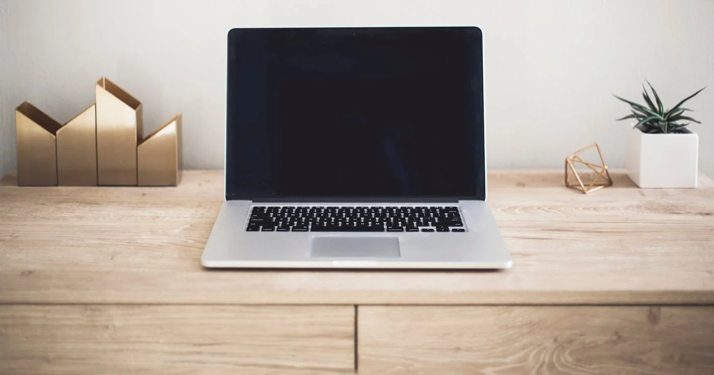 Laptop on a wooden desk, product launch workspace