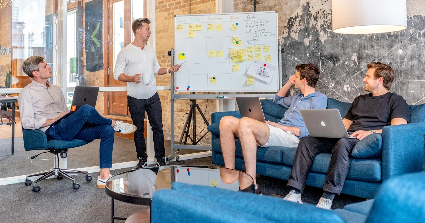 Startup team working on funding strategy around a whiteboard