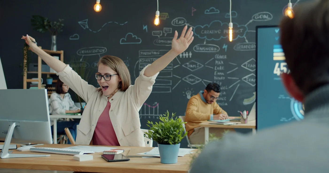 Startup team celebrating success in a modern office