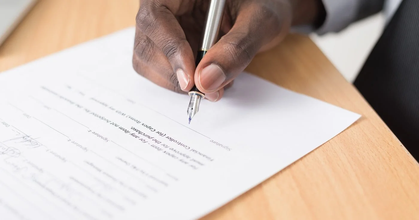 Person signing an equity contract with a fountain pen